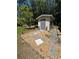 View of the shed with decorative statues and gravel landscaping in a backyard setting at 8951 Sw 202Nd Avenue Rd, Dunnellon, FL 34431