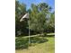 Scenic yard view with American flag flying proudly amidst lush greenery and clear blue skies at 8951 Sw 202Nd Avenue Rd, Dunnellon, FL 34431