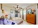 Bedroom featuring a patterned comforter, a ceiling fan, and a dresser for storage and a cozy space at 9050 Sw 101St Ln, Ocala, FL 34481