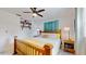 Cozy bedroom featuring a wooden bed frame, neutral linens, and a stylish ceiling fan for added comfort at 9050 Sw 101St Ln, Ocala, FL 34481