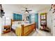 Comfortable bedroom featuring a wooden bed frame, soft linens, and a ceiling fan for a relaxing atmosphere at 9050 Sw 101St Ln, Ocala, FL 34481