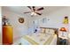 Bedroom with a patterned comforter, a ceiling fan, and decorative accents for a cozy, inviting atmosphere at 9050 Sw 101St Ln, Ocala, FL 34481