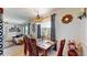Inviting dining room featuring a wooden table, stylish decor, and a window that fills the space with natural light at 9050 Sw 101St Ln, Ocala, FL 34481