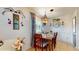 Cozy dining room featuring a wooden table set for four, accented by a stylish light fixture and charming decor at 9050 Sw 101St Ln, Ocala, FL 34481
