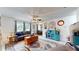 The living room offers warm toned walls, a patterned rug, ceiling fan, and an abundance of decor that create a welcoming space at 9050 Sw 101St Ln, Ocala, FL 34481