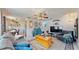 Comfortable living room featuring a ceiling fan, cozy seating arrangements, charming decor, and neutral colored walls at 9050 Sw 101St Ln, Ocala, FL 34481