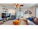 Inviting living room features neutral walls, a ceiling fan, lots of seating, and charming decor elements that add character at 9050 Sw 101St Ln, Ocala, FL 34481