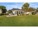 Expansive backyard with lush lawn, patio area, manicured hedges and mature palm trees at 9452 Sw 93Rd Loop, Ocala, FL 34481