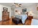 Comfortable bedroom features a queen-size bed, hardwood floors, and matching dressers at 9452 Sw 93Rd Loop, Ocala, FL 34481