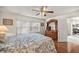 Spacious bedroom with hardwood floors and lots of storage space, showing a large bed and a wooden dresser at 9452 Sw 93Rd Loop, Ocala, FL 34481
