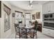 Cozy breakfast nook features a table and chairs next to white cabinets and oven, with lots of natural light at 9452 Sw 93Rd Loop, Ocala, FL 34481