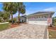 Charming home with a two-car garage, paved driveway, palm trees and an American flag at 9452 Sw 93Rd Loop, Ocala, FL 34481