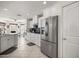 Modern kitchen showcasing white cabinets, stainless steel appliances, and an eat-in area with natural light at 9452 Sw 93Rd Loop, Ocala, FL 34481