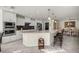 Gourmet kitchen featuring a large island with bar seating, built-in appliances, and pendant lighting at 9452 Sw 93Rd Loop, Ocala, FL 34481