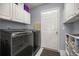Functional laundry room with washer, dryer, overhead cabinets and ample storage space at 9452 Sw 93Rd Loop, Ocala, FL 34481
