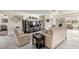 Comfortable living room with neutral tones, tile flooring, and access to an outdoor patio through sliding glass doors at 9452 Sw 93Rd Loop, Ocala, FL 34481