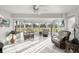 Bright sunroom features white tile floors and floor to ceiling windows overlooking the backyard at 9452 Sw 93Rd Loop, Ocala, FL 34481