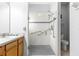 Modern bathroom with single sink vanity and a frameless glass walk-in shower with accessibility grab bars at 9773 Sw 90Th St, Ocala, FL 34481