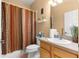 Bathroom with a shower-tub combination, floral decor, and a wood vanity at 9773 Sw 90Th St, Ocala, FL 34481