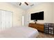 Bedroom with a bed, ceiling fan, dresser, and closet at 9773 Sw 90Th St, Ocala, FL 34481
