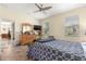Bright bedroom boasting a large bed, dresser with a mirror, and an open doorway to another room at 9773 Sw 90Th St, Ocala, FL 34481