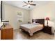 Comfortable bedroom featuring a bed and a dark-wood dresser and nightstand at 9773 Sw 90Th St, Ocala, FL 34481
