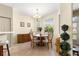 Bright dining area featuring a round table set, adjacent to the entry door at 9773 Sw 90Th St, Ocala, FL 34481