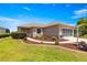 Charming single-story home with a well-manicured lawn, plants, and an attached screened garage at 9773 Sw 90Th St, Ocala, FL 34481