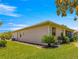 The home has a well-manicured lawn and tropical landscaping to complement the beige stucco exterior at 9773 Sw 90Th St, Ocala, FL 34481