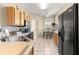 Kitchen area with wood cabinets, black appliances, and dining table set near window at 9773 Sw 90Th St, Ocala, FL 34481