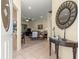 Inviting living room featuring tiled flooring, neutral walls, and comfortable furnishings at 9773 Sw 90Th St, Ocala, FL 34481