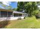 Secluded backyard with a screened in porch and an air conditioning unit at 9855 Sw 85Th Terrace Rd # A, Ocala, FL 34481