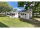 Well-maintained backyard with lush green lawn, mature trees, and lanai at 9855 Sw 85Th Terrace Rd # A, Ocala, FL 34481