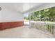 Spacious front porch with white railing and brick accents, offering a charming outdoor space at 9855 Sw 85Th Terrace Rd # A, Ocala, FL 34481