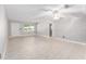 Bright living room featuring tile floors, a ceiling fan, and a front entrance door at 9855 Sw 85Th Terrace Rd # A, Ocala, FL 34481