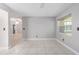Open living room with tile flooring and natural light from an adjacent window at 9855 Sw 85Th Terrace Rd # A, Ocala, FL 34481