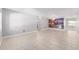 Bright living room with tiled floors and decorative wall art, illuminated by a ceiling fan at 9855 Sw 85Th Terrace Rd # A, Ocala, FL 34481