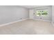 A living room with tiled floors and a window bringing in light at 9855 Sw 85Th Terrace Rd # A, Ocala, FL 34481