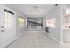 Living area with tile floors, a ceiling fan, and view of the kitchen at 9855 Sw 85Th Terrace Rd # A, Ocala, FL 34481