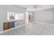 Open living room showcasing stylish tile flooring and an opening to the kitchen at 9855 Sw 85Th Terrace Rd # A, Ocala, FL 34481