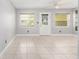 The bright living room features tile floors, a back door, and two windows at 9855 Sw 85Th Terrace Rd # A, Ocala, FL 34481