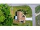 Aerial view of cozy home showing roof, driveway and yard with mature trees surrounding the property at 10668 Sw 85Th Ter, Ocala, FL 34481