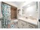 A clean bathroom features tiled shower and tub, vanity, and stylish shower curtain at 10668 Sw 85Th Ter, Ocala, FL 34481