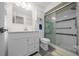 Bright bathroom with white vanity, modern sliding glass door shower, and tiled flooring at 10668 Sw 85Th Ter, Ocala, FL 34481
