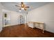 Spacious bedroom with wood floors, ample natural light, a sewing desk, and access to a utility room at 10668 Sw 85Th Ter, Ocala, FL 34481