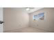 A simple bedroom with a large window and neutral colored carpet at 10668 Sw 85Th Ter, Ocala, FL 34481