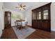 A formal dining room features a large antique hutch and hardwood flooring at 10668 Sw 85Th Ter, Ocala, FL 34481