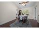 Cozy dining area featuring hardwood floors, natural light, and a stylish area rug at 10668 Sw 85Th Ter, Ocala, FL 34481