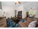 The cozy living room has a ceiling fan and opens to the dining area at 10668 Sw 85Th Ter, Ocala, FL 34481