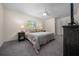 Comfortable main bedroom features a ceiling fan, large window, and plush carpeting at 10668 Sw 85Th Ter, Ocala, FL 34481